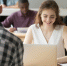 young-smiling-woman-working-laptop-coworking-office-space - Новый Компаньон