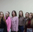 Стоит группа людей в кадре, почти по пояс. Позади них стена. На фотографии: девушки-студентки из ЧелГУ и сотрудники Главного управления, Изображение. - Главное управление координации развития туризма