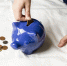 blue-piggy-bank-filled-with-coins_1.jpg - GorodnaBire.Ru