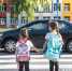 back school education concept with girl kids elementary students carrying backpacks going class tn - Министерство здравоохранения