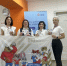 Работники центра позируют с плакатом. - Козельский район