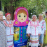 Участники клуба Добрые встречи позируют у деревянной матрешки - Министерство труда и соцразвития