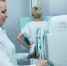 mid-adult-smiling-nurse-taking-xray-patient-clinic - ТРК Щелково