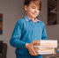 first_grade_boy_studying_home_holding_bunch_books_getting_ready - Новый Компаньон