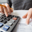Closeup of Accountant Hands Counting on Calculator - РИА 7 Новостей