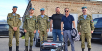 Четверо военнослужащих и двое мужчин позируют рядом с переносным генератором на парковке - 168.Ru
