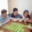 Пожилые женщины за столом в помещении играют в настольную карточную игру «Мемо» - 168.Ru