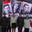 Группа школьников/участников на сцене перед большим экраном с изображениями молодогвардейцев и надписями о «Молодой гвардии». - 168.Ru