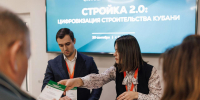 момент регистрации или раздачи материалов на сессии «Стройка 2.0: цифровизация строительства Кубани»: сотрудница передаёт буклет участнику, на фоне — экран с названием мероприятия. - Департамент строительства