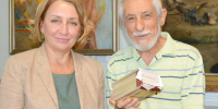Александр Марьяхин передаёт директору комплекса алуштинских музеев Светлане Немирович комплект открыток со своими работами. - Крымская правда