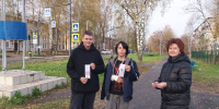 три человека на тротуаре держат длинные бумажные закладки (карманные памятки) - 168.Ru