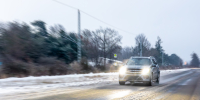 car-speeds-along-winter-highway-with-headlights-winter-roadtrip-motion.jpg - Gorod3466.Ru