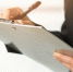 close-up-woman-writing-clipboard-with-pen - ТРК Щелково