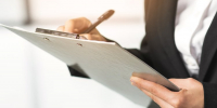 close-up-woman-writing-clipboard-with-pen - ТРК Щелково