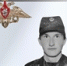 Портрет мужчины в военной форме на сером фоне, в верхнем углу эмблема - 168.Ru